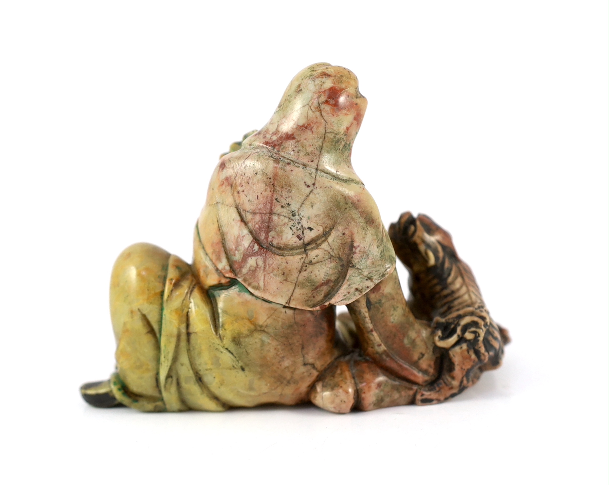 A Chinese soapstone group of a seated luohan and lion-dog, 19th/20th century